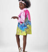 Girl in pink top and Dubai desert print skirt with front buttons.