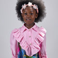 Girl in pink top and Dubai desert print skirt with front buttons.