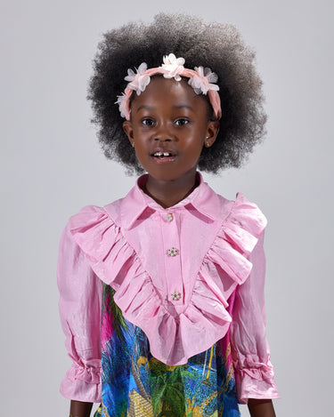 Girl in pink top and Dubai desert print skirt with front buttons.