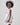 Girl in taffeta A-line dress with flamingo print, tulle sleeves, and back bow.