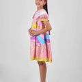 Girl in Dubai skyline print shirt dress with lace collar and puff sleeves.