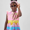 Girl in linen taffeta dress with Atlantis-themed print and white hem.