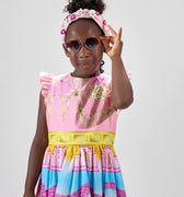 Girl in linen taffeta dress with Atlantis-themed print and white hem.