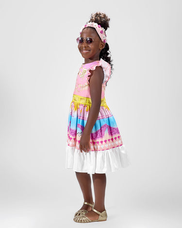 Girl in linen taffeta dress with Atlantis-themed print and white hem.