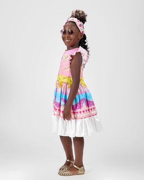 Girl in linen taffeta dress with Atlantis-themed print and white hem.