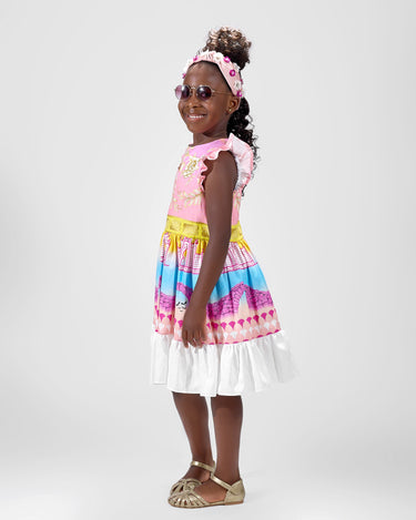 Girl in linen taffeta dress with Atlantis-themed print and white hem.