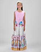 Girl in tiered Dubai-print maxi dress with lace panels and open-back tie.