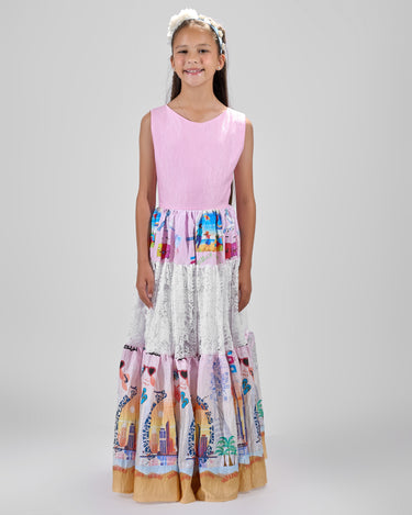 Girl in tiered Dubai-print maxi dress with lace panels and open-back tie.