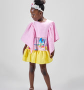 Girl in colour-block crinkle taffeta dress with yellow hem and pink sleeves.
