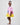 Girl in colour-block crinkle taffeta dress with yellow hem and pink sleeves.