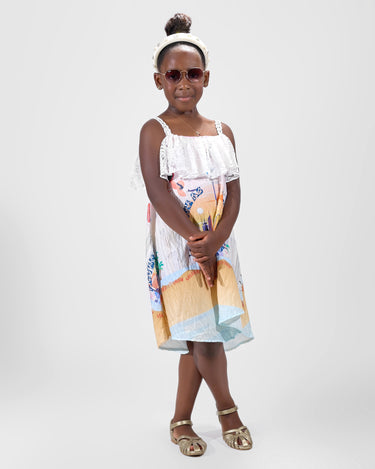 Girl in Dubai-themed crinkle taffeta dress with desert and skyline print.