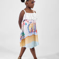 Girl in Dubai-themed crinkle taffeta dress with desert and skyline print.