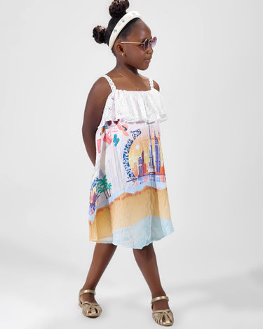 Girl in Dubai-themed crinkle taffeta dress with desert and skyline print.