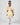 Product photo of a young girl modeling a yellow floral dress with ruffled sleeves, part of the Rehoboth Kidz summer collection, against a white background