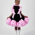 Girl in black velvet dress with pink organza ruffles and voluminous skirt.