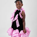Girl in black velvet dress with pink organza ruffles and voluminous skirt.