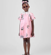 Girl in pink A-line dress with panda print and lace collar.