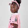 Girl in pink A-line dress with panda print and lace collar.