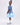 Girl wearing soft blue embroidered lace dress with puff sleeves and tulle hem.