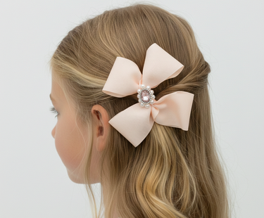 Blonde hair with a large pink bow accessory on a white background
