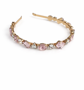 Gold hoop earring with pink gemstones on a white background