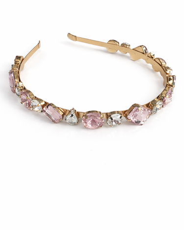 Gold hoop earring with pink gemstones on a white background