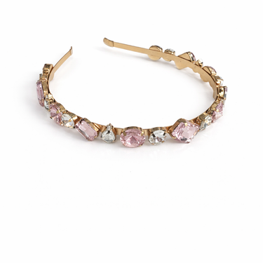 Gold hoop earring with pink gemstones on a white background