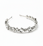 Silver headband with clear gemstones on a white background