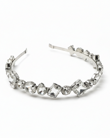Silver headband with clear gemstones on a white background