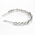 Silver headband with crystal-like stones on a white background