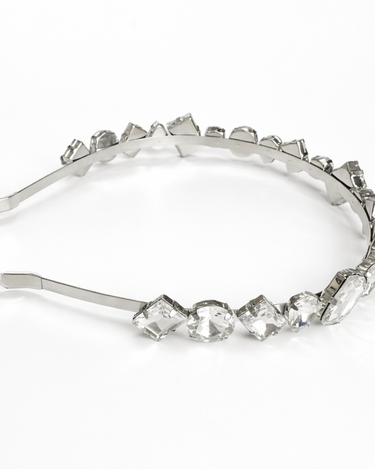 Silver headband with crystal-like stones on a white background